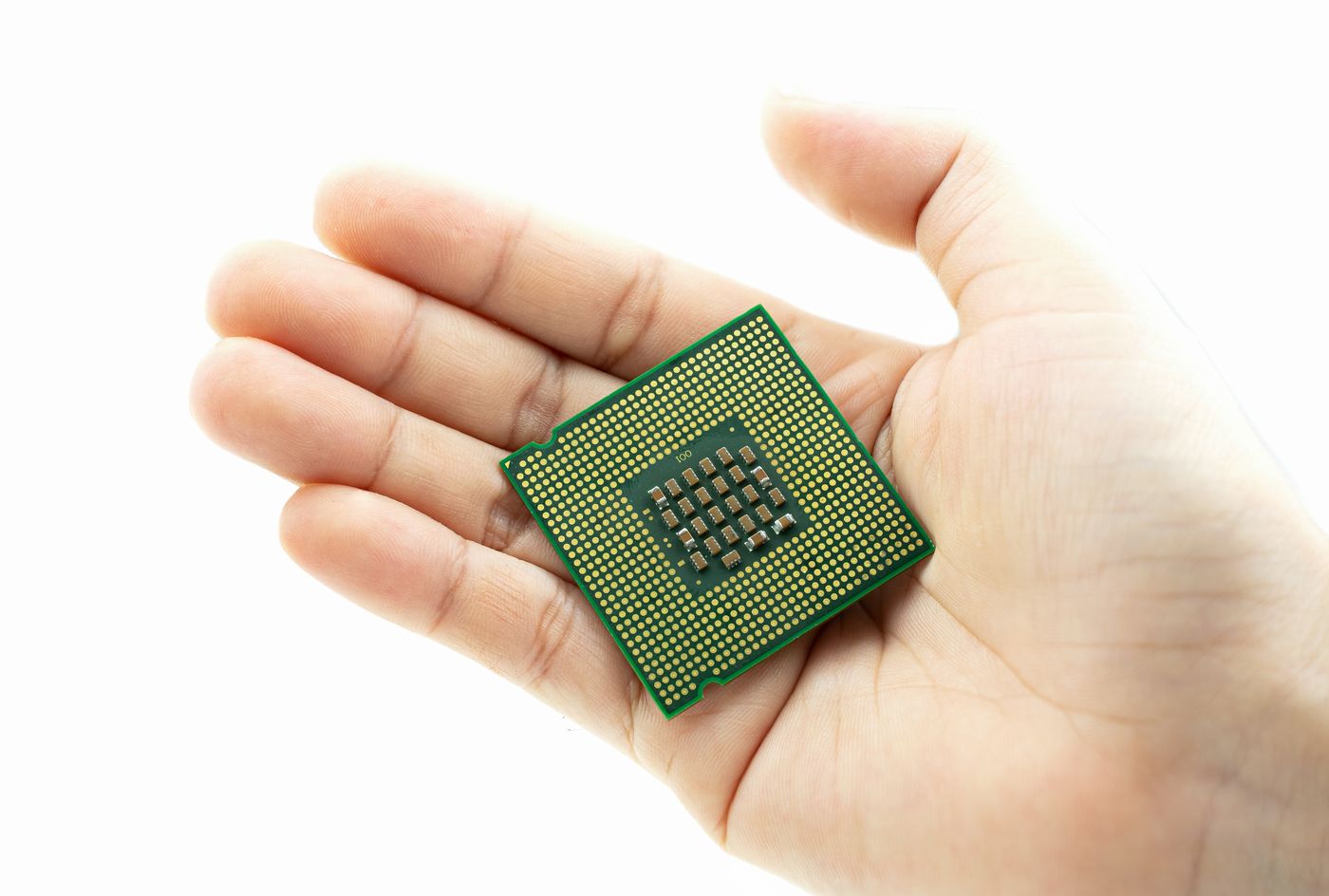 Realistic cpu back view processor chip in hand